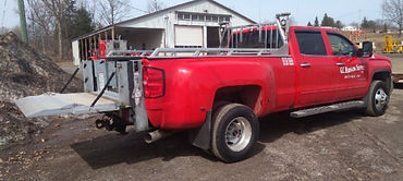 Red pickup truck parked in front of garage