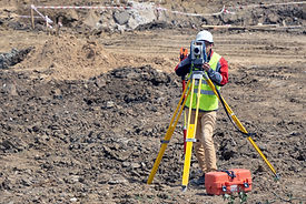 The surveyor is shooting at a building site
