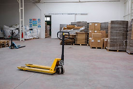 Hand pallet truck, in the warehouse part of the factory. Selective Focus pallet truck
